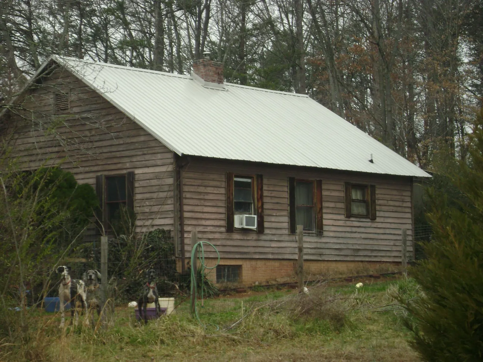 White metal roof on an old wood sided farmhouse, from a Metal Roof Installation job in Soledad